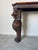 Striking vintage Hollywood Regency–style console table crafted in richly finished carved wood, featuring dramatic...