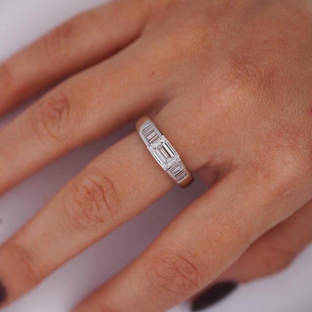 A sleek and modern 14K white gold ring featuring a striking 1.53ct emerald-cut lab-grown diamond in an elegant east-west...