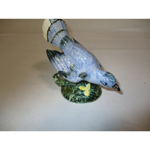 Vintage 1940's Stangl pottery hand painted blue bird figurine. This ceramic bird is perched on a branch with its wings...