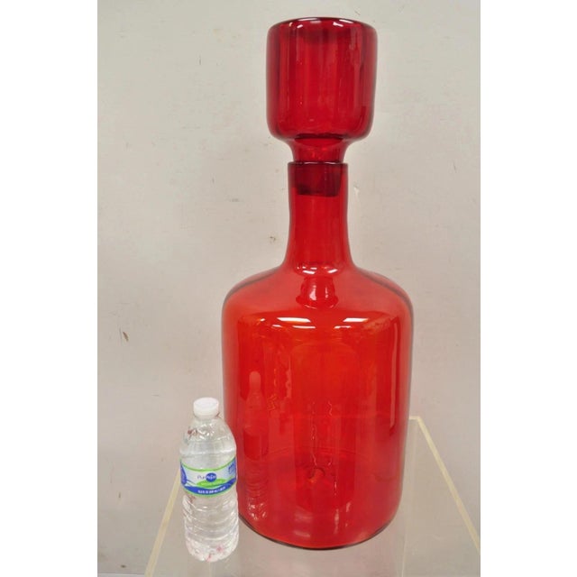 Mid Century Modern Blenko Large Red Blown Art Glass Vase Vessel Jug with Stopper. Circa Mid 20th Century. Measurements:...