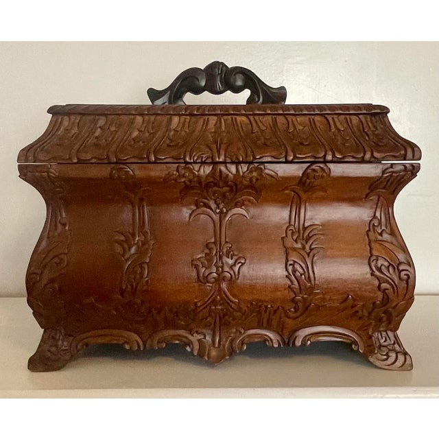 This carved antique box used for a tea caddy, can also be used for a tobacco humidor, a gaming box, or perhaps even as a...