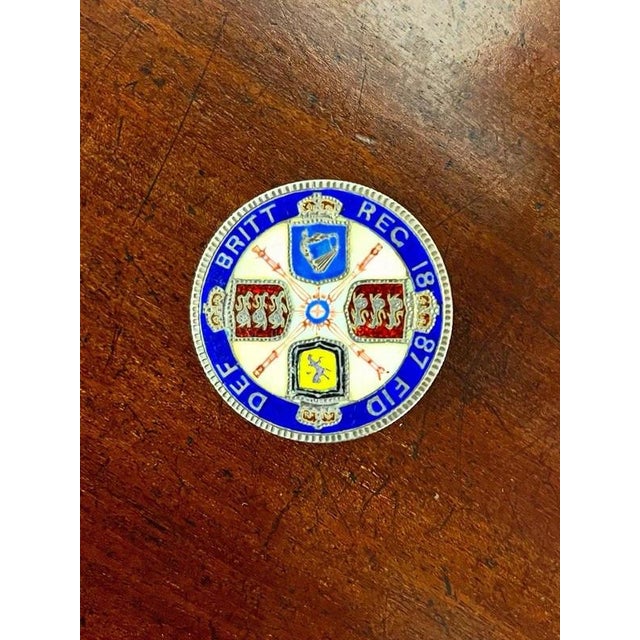Victorian Silver Enamelled Jubilee Coin Brooch, 1887 Material: Silver, Polychrome Enamel A distinctive Victorian silver...