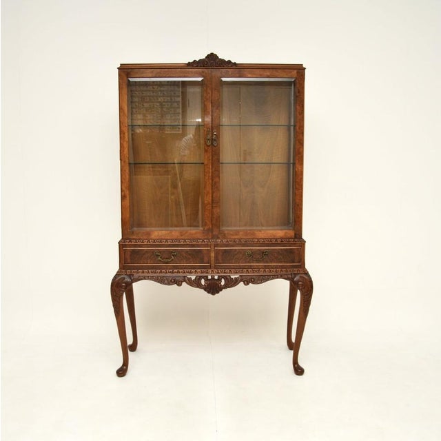 A superb antique burr walnut Queen Anne style display cabinet. This was made in England, it dates from around the 1930’s...