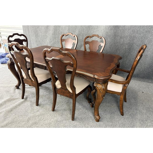 This elegant 7-piece banded dining set showcases a classic traditional design with a beautifully shaped tabletop, rich...