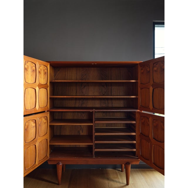 A striking mid-century highboard crafted in Norway from richly grained teak. The piece features a sculptural geometric...