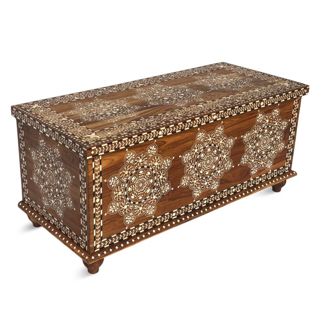 Handcrafted in India from solid teak wood, this vintage inlay storage trunk is a striking blend of artistry and...