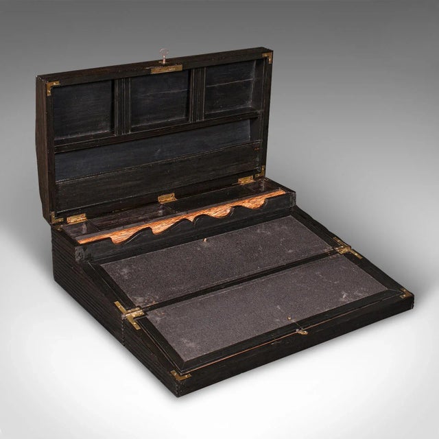 This is an antique gentleman's correspondence box. A Ceylonese ebony campaign writing slope, dating to the early Victorian...