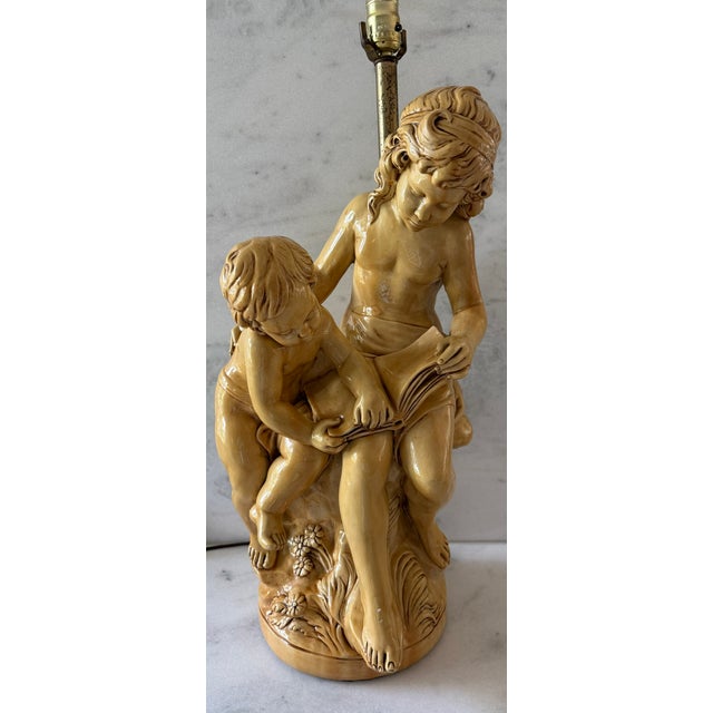Very large vintage Italian style chalkware (plaster) table lamp featuring two children reading together.