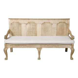 English 19th Century Oak Bench with Carved Back, Downswept Arms and Cushion For Sale
