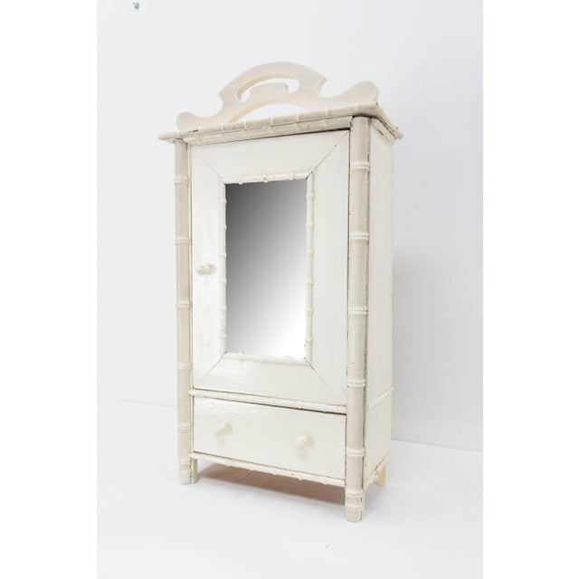 French mirror door miniature wardrobe 1900 in the bamboo style, It can be used has a bathroom cabinet. Oil painted. One...