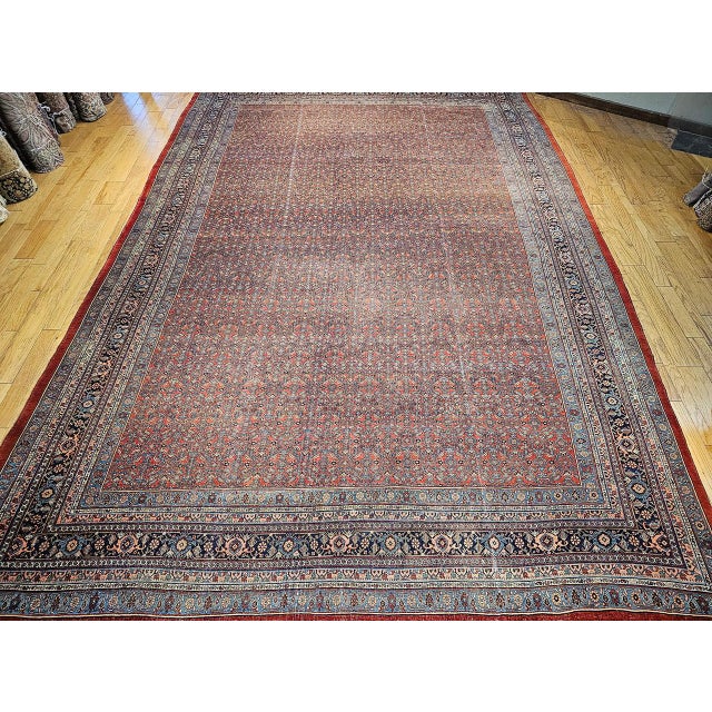 A remarkable example of early 20th-century Persian craftsmanship, this vintage oversized Bidjar rug showcases the timeless...