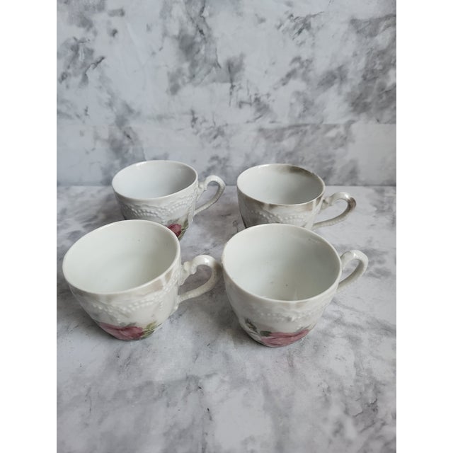 This is a set of 4 late 19th century Leuchtenburg, German porcelain demitasse tea cups. Each cup is marked on the base.