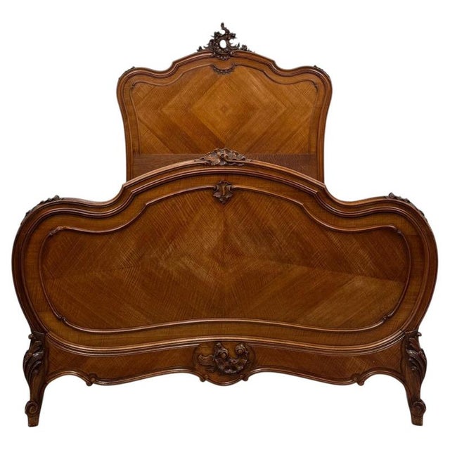 An impressive and finely crafted 19th-century French double bed, beautifully constructed in walnut and distinguished by...
