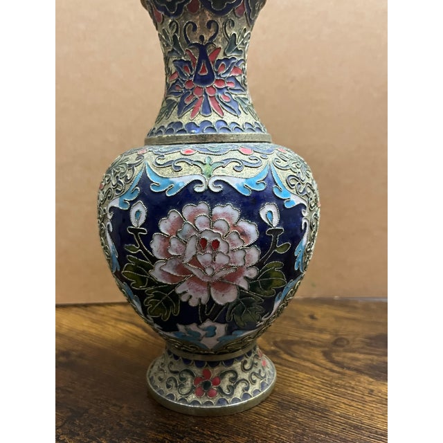 A beautifully handcrafted vintage Chinese cloisonné enamel vase featuring an elegant pink peony surrounded by intricate...