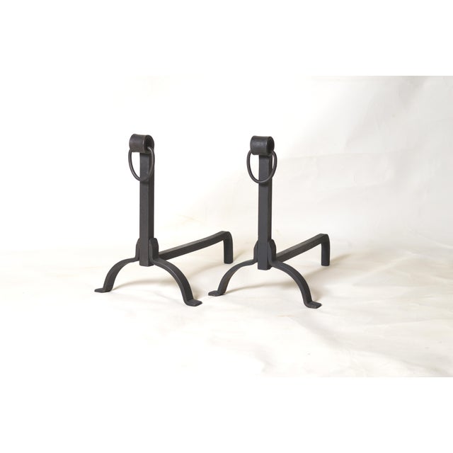 This pair of wrought iron andirons embodies traditional craftsmanship and the robustness of classic fireplace accessories....