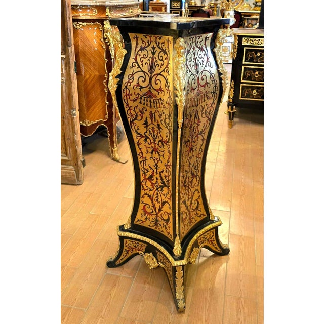 A striking example of French decorative furniture, this elegant pedestal stand combines dramatic black woodwork with...