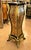 A striking example of French decorative furniture, this elegant pedestal stand combines dramatic black woodwork with...
