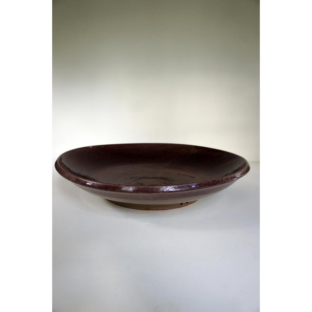 Monumental vintage decorative plate / platter signed Lively Earth. Nuanced maroon glaze on the inside, beige tone glaze on...