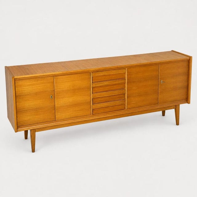 Mid-century modern architectural sideboard in premium okoumé. Discover a rare masterpiece of minimalist perfection from...