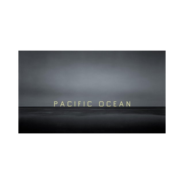 A twilight photograph of the Pacific Ocean, presenting a panoramic view of a vast, serene evening—epic in its stillness,...