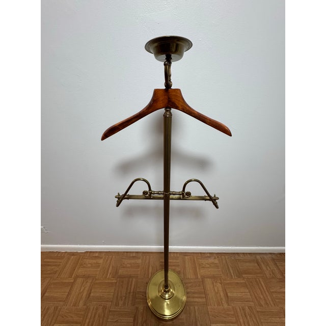 Elegant and sculptural, this vintage gentleman’s valet stand combines warm, finely grained wood with richly patinated...