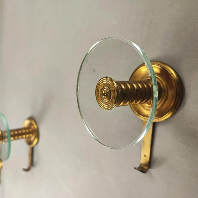 Vintage Fontana Arte style coat hangers with brass frame and crystal disc, 1950s design. Excellent vintage condition, no...