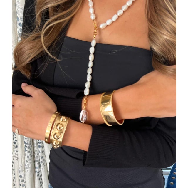 This new cuff features a clean and modern stud motif. Stack with other mini cuffs or stretch bracelets. Handmade. One size...