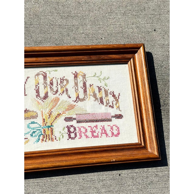 Antiquated "Give Us This Day Our Daily Bread" needlepoint vintage wall hanging with original wood frame. Size: Height: 14...