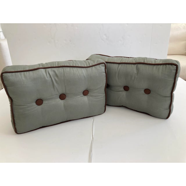 Modern Pair of Toss Pillows in a rectangular form. Gorgeous details with contrast brown trim and buttons. Add some Modern...