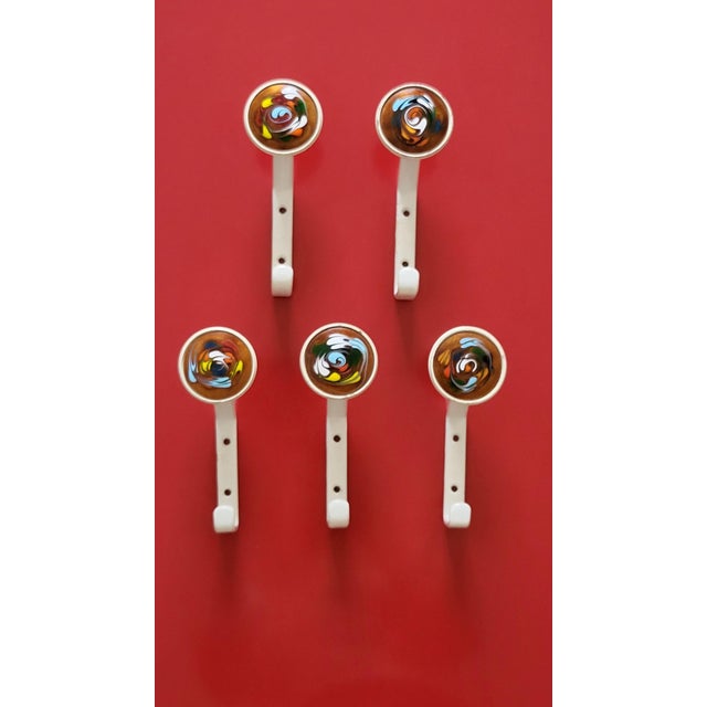 Gorgeous set of 5 are and colourful enamel, metal and wooden wall hooks in modernist fashion from the 1960s - a complete...