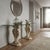 A Neoclassical-style console table featuring a clear glass top that highlights its elegant design and quality materials....
