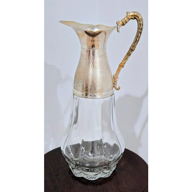 Add timeless sophistication to your table with this exquisite Italian pitcher, crafted with a gleaming silver-plated top...