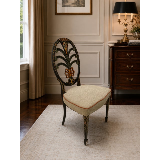 A striking vintage Neoclassical plume-back accent chair featuring an elaborate pierced oval back centered by a dramatic...