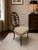 A striking vintage Neoclassical plume-back accent chair featuring an elaborate pierced oval back centered by a dramatic...