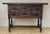 Walnut console from the early 20th century with tablet top on a frieze with two drawer fronts decorated with carved with...