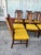 Vintage mid-century modern dining chairs with walnut-finished wood frames. This set of Eight features tall backs with...
