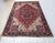 8’ 6” x 11’ 5” Vintage Persian Heriz room size rug from the mid 1900s in a red and ivory color background with the central...