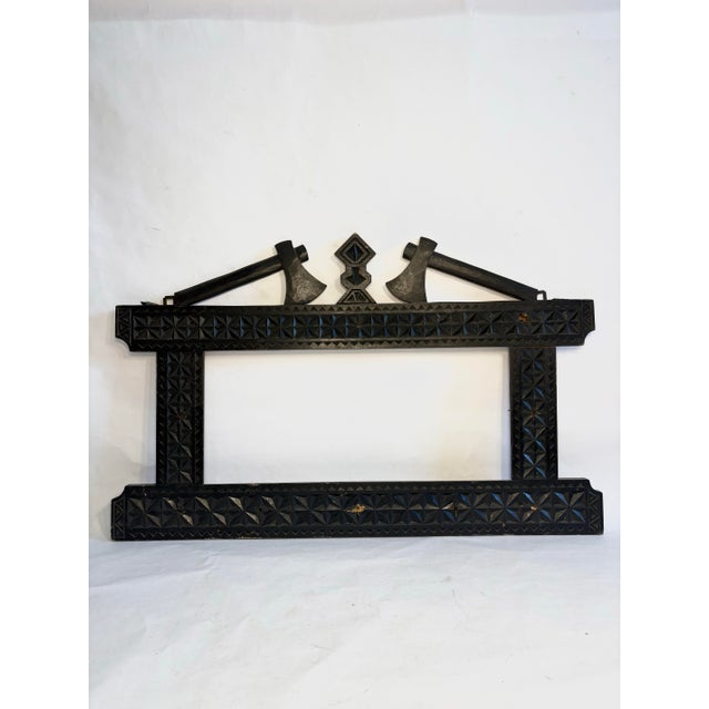 Intricately carved mirror/picture frame hand carved with deep, rhythmic, geometric patterns classic to the tramp art...