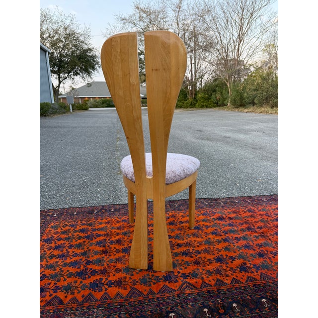 This chair has beautiful a maple frame with a split back going all the way down to form the legs. The sculptural back with...
