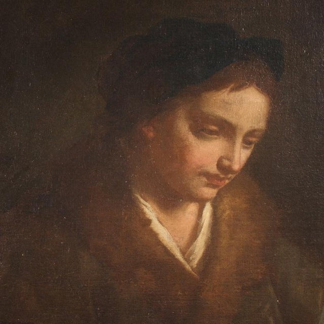 An antique 17th-century Italian oil painting on canvas depicting the portrait of a young scholar or artist, executed with...