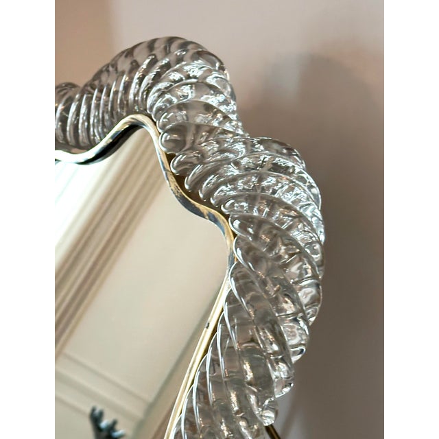This Murano glass vanity mirror by Barovier and Toso, produced in Italy circa 1940s, reflects the sculptural qualities of...