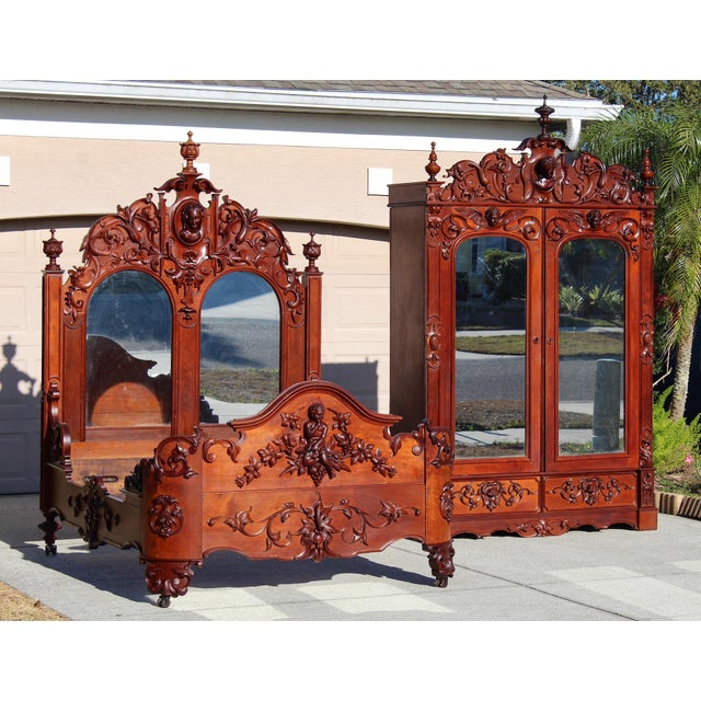 An extraordinary and visually commanding mid-19th century Rococo Revival bedroom set, consisting of a highly carved custom...