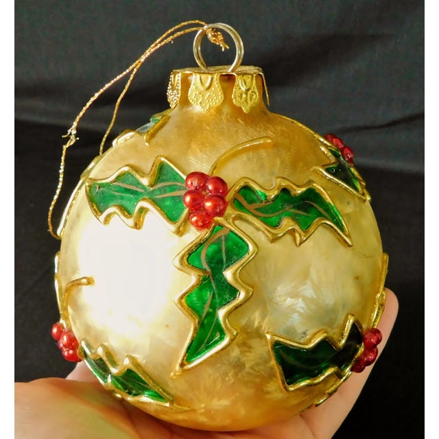 Beautiful set of four large vintage gold foil shmmer glass ornaments with hand painted red & green mistletoe. They are...