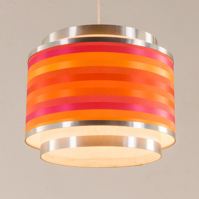 This colorful pedant lamp was produced by targetti sankey in italy in the 1970s. The lamp features a cylindrical, layered...