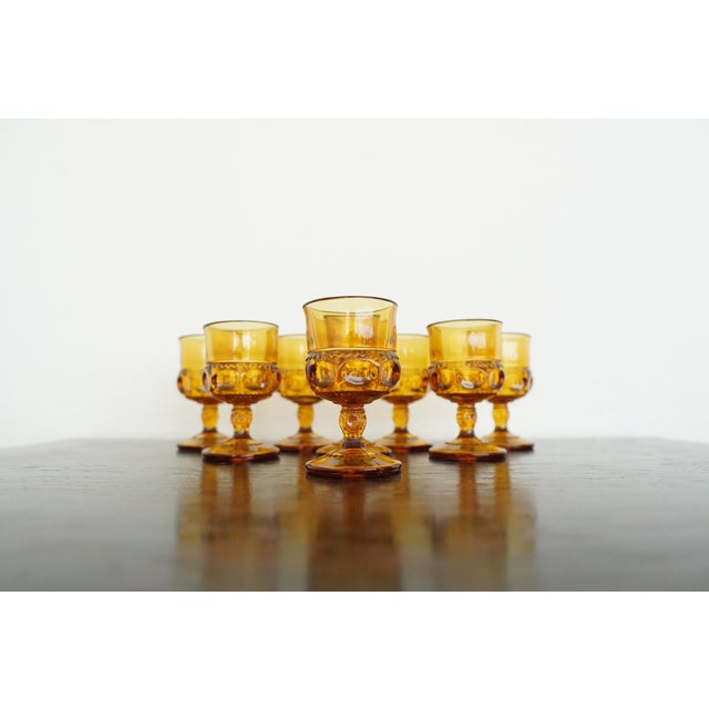 This vintage set of eight amber glass cordial glasses by Indiana Glass features the classic King’s Crown (Thumbprint)...
