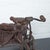 Pair of charming vintage hand-wrought iron tricycle sculptures with wicker cargo baskets. Large tricycle: 18.5"w x 9"d x...