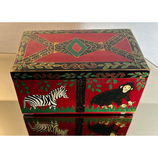 Vintage hand painted wood and paper Mache dresser box. Decorated with zebras and monkeys with red, green, white and gold...