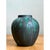 This vase presents a classic rounded silhouette, its body swelling generously from a narrower base through a broad...