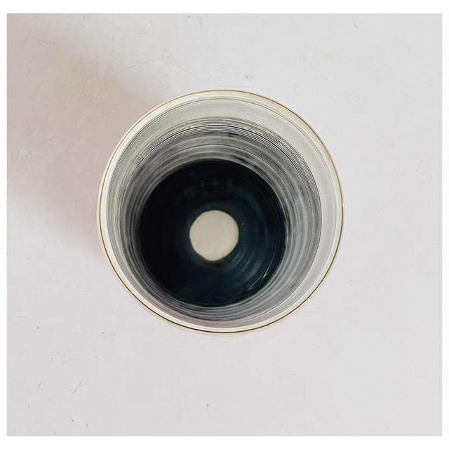 A transparent glass with a minimalist design, featuring fine horizontal stripes on the surface. Suitable for serving cold...