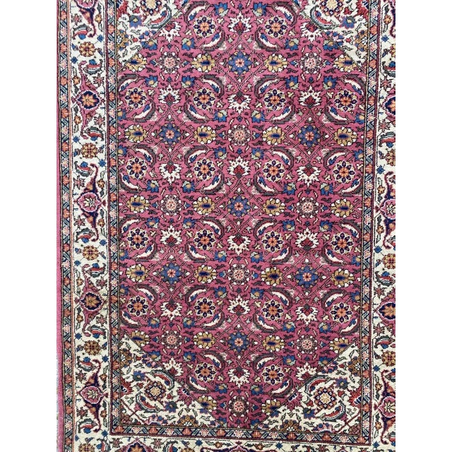 Very beautiful midcentury rug with nice floral decorative design and beautiful pink field color, entirely hand knotted...